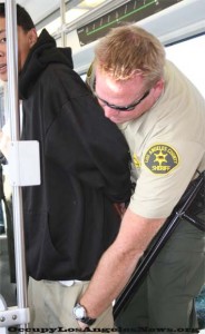 Los Angeles County Sheriff arresting an unidentified suspect on a metro train. The FBI has indicted 18 County Sheriffs on multiple felony counts. The sheriff in this photo is unidentified. Los Angeles County Sheriff arresting an unidentified suspect on a metro train. The FBI has indicted 18 County Sheriffs on multiple felony counts. The sheriff in this photo is unidentified.